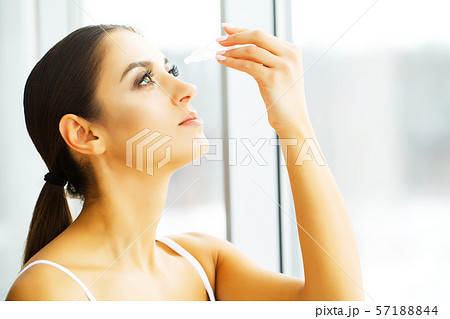 Young Beautiful Woman With Eyedrops. Vision And Medicine Concept Young Beautiful Woman With Eyedrops. Vision And Medicine Concept 57188844