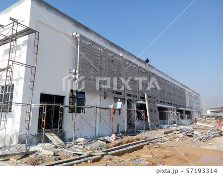 GRC (Glass Fibre Reinforce Concrete) with Islamic geometry pattern installation work at the construction site by the construction workers. GRC (Glass Fibre Reinforce Concrete) with Islamic geometry pattern installation work at the construction site by the construction workers. 57193314