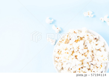 Scattered popcorn over yellow background Scattered popcorn over yellow background 57194114