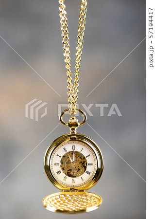 Vintage pocket watch hanging on a chain. Roman Vintage pocket watch hanging on a chain. Roman 57194417