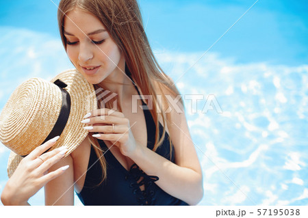 Girl on summer party in the swimming pool 57195038