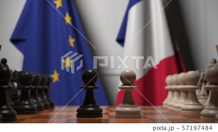 Flags of the EU and France behind chess board. The first pawn moves in the beginning of the game Flags of the EU and France behind chess board. The first pawn moves in the beginning of the game 57197484