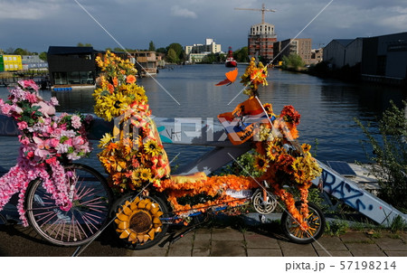 Bicycle decorated with flowers on a dutch bridge in amsterdam Bicycle decorated with flowers on a dutch bridge in amsterdam 57198214