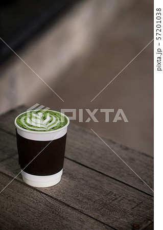 hot matcha green tea latte take away cup on wood table 57201038