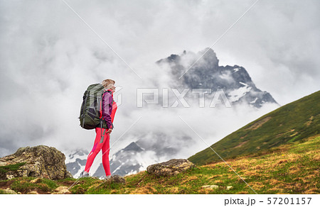 Portrait of hiker with a backpack at the beautiful mountains background. Portrait of hiker with a backpack at the beautiful mountains background. 57201157