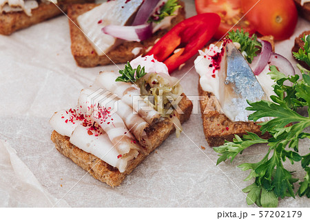 Delicious canapes with herring.Macro of delicious 57202179