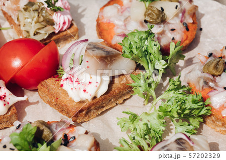 Delicious canapes with herring.Macro of delicious 57202329