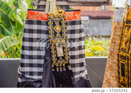 Traditional balinese offerings to gods in Bali with flowers and aromatic sticks 57203242