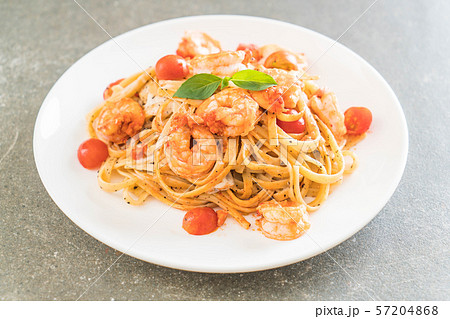 spaghetti with shrimps, tomatoes, basil and cheese 57204868