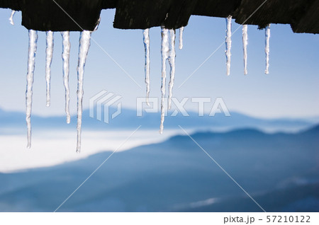 Icicles on the roof of the house Icicles on the roof of the house 57210122