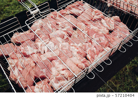 View from side of barbeque process in garden View from side of barbeque process in garden 57210404