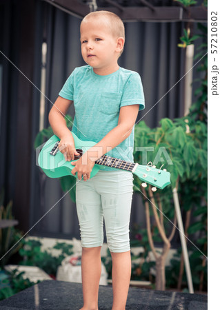 Portrait of a cute boy with ukulele Portrait of a cute boy with ukulele 57210802