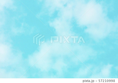 Abstract background texture of a vibrant teal blue sky with soft clouds Abstract background texture of a vibrant teal blue sky with soft clouds 57210998