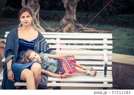 Mother and daughter in a park Mother and daughter in a park 57211183