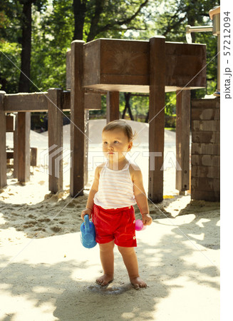 Cute kid with watering can in a playground 57212094