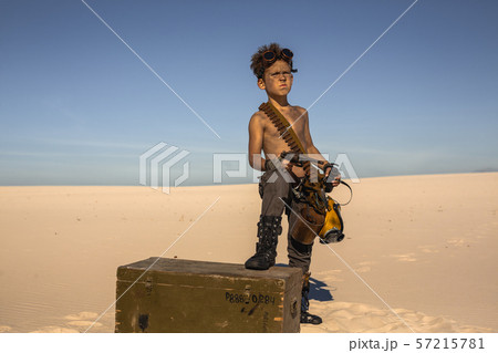 Post-apocalyptic boy outdoors in desert. 57215781