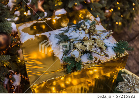 Christmas gold box with gifts. Golden balls and 57215832