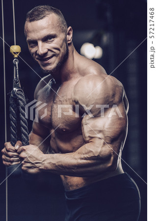 Brutal strong men workout bodybuilding background - muscular bodybuilder men doing exercises in gym Brutal strong men workout bodybuilding background - muscular bodybuilder men doing exercises in gym 57217468