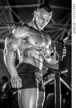 Brutal strong men workout bodybuilding background - muscular bodybuilder men doing exercises in gym Brutal strong men workout bodybuilding background - muscular bodybuilder men doing exercises in gym 57217503