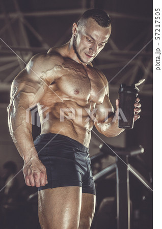 Brutal strong men workout bodybuilding background - muscular bodybuilder men doing exercises in gym Brutal strong men workout bodybuilding background - muscular bodybuilder men doing exercises in gym 57217505