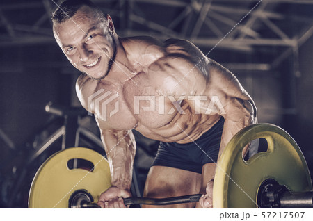 Brutal strong men workout bodybuilding background - muscular bodybuilder men doing exercises in gym 57217507