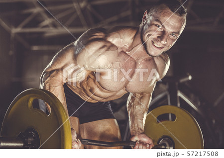 Brutal strong men workout bodybuilding background - muscular bodybuilder men doing exercises in gym Brutal strong men workout bodybuilding background - muscular bodybuilder men doing exercises in gym 57217508