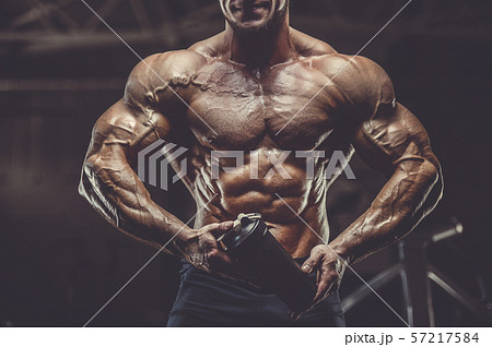 Brutal men muscles workout bodybuilding concept background muscular bodybuilder men exercises in gym 57217584