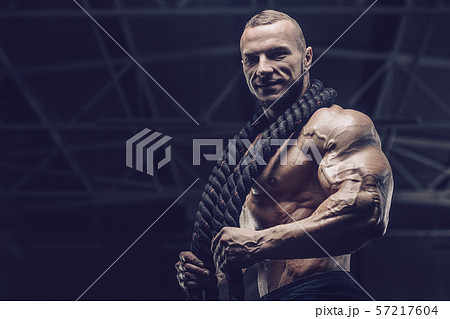 Brutal men muscles workout bodybuilding concept background muscular bodybuilder men exercises in gym 57217604