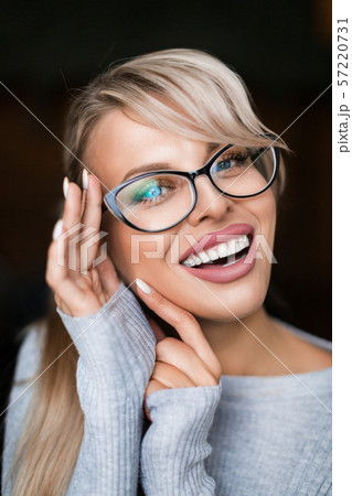 Close up photo of a smiling woman in eyeglasses. Eyesight concept. Close up photo of a smiling woman in eyeglasses. Eyesight concept. 57220731