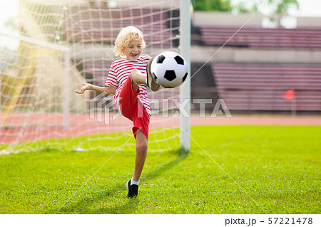Kids play football. Child at soccer field. Kids play football. Child at soccer field. 57221478