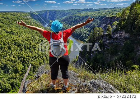 Woman is pleased to climbing a mountain. 57222172