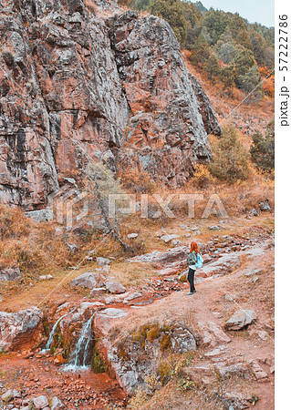 Female hiker walking in mountains forest. 57222786