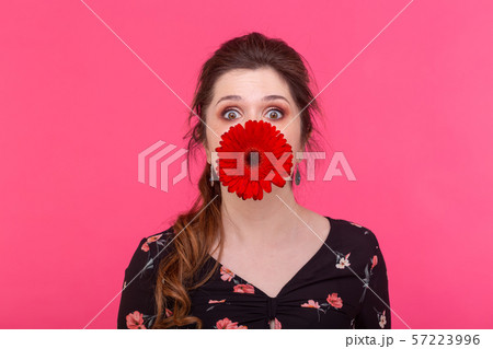 Emotions, flowers and people concept - Happy woman having fun with gerbera flowers 57223996