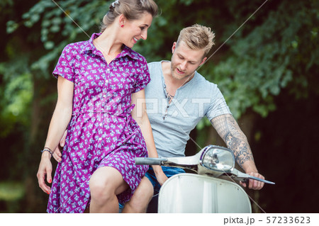Woman sitting on her boyfriend's lap 57233623