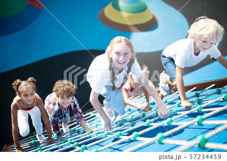 Children feeling involved in climbing all together Children feeling involved in climbing all together 57234459