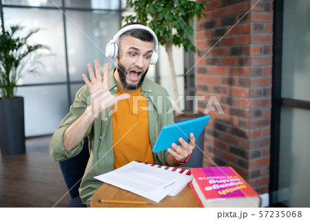 Emotional student having video lesson in foreign language Emotional student having video lesson in foreign language 57235068