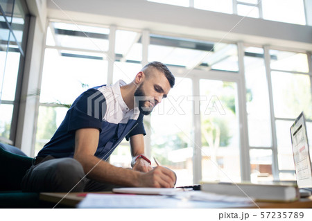 Businessman noting down some statements while working hard 57235789
