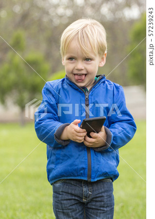 Child using a mobile phone 57239243