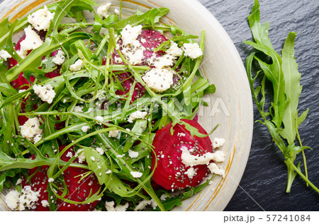 Top view at clay dish with beetroot arugula and 57241084