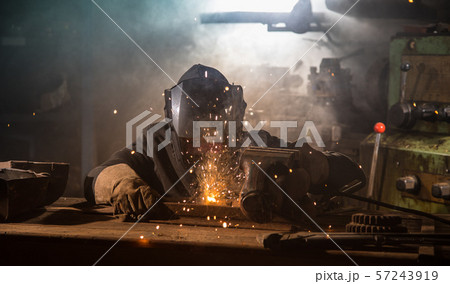 Welder is welding metal part in factory Welder is welding metal part in factory 57243919