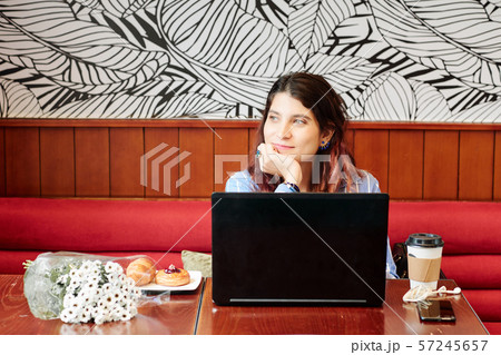 Smiling woman in cafe Smiling woman in cafe 57245657