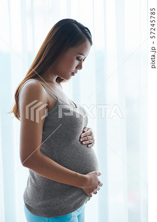 Pregnant woman touching her big belly 57245785