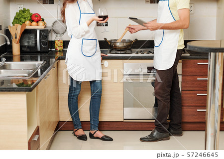 Couple talking and cooking Couple talking and cooking 57246645