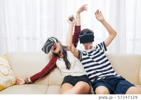 Teenagers playing action vr games Teenagers playing action vr games 57247129