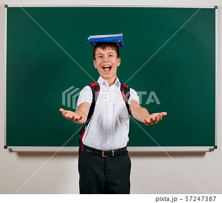 Portrait of a school boy posing with backpack and Portrait of a school boy posing with backpack and 57247387