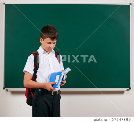 Portrait of a school boy posing with backpack and Portrait of a school boy posing with backpack and 57247399