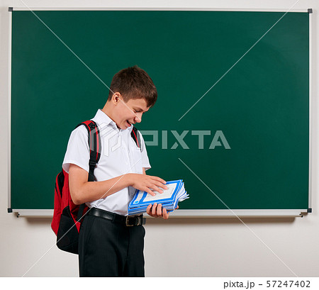 Portrait of a school boy posing with backpack and 57247402