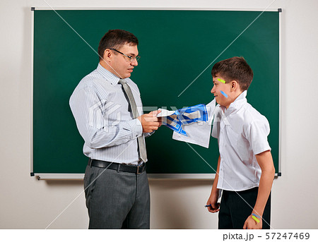 Portrait of a teacher and funny schoolboy with low 57247469