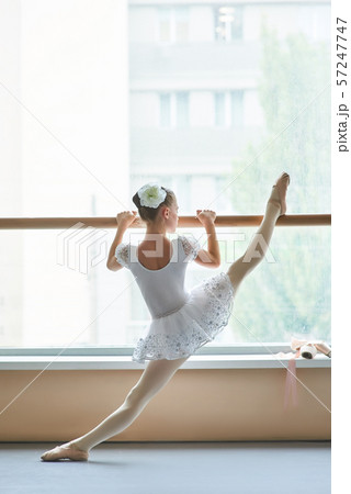 Ballet girl doing exercises at ballet barre. 57247747