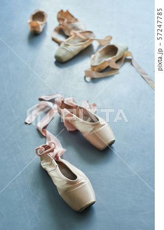 Pair of old ballet shoes on grey background. 57247785